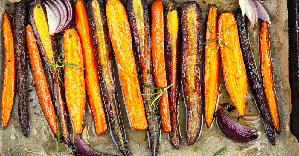 Seven Days of Sweet Heat Your Complete Hot Honey Recipe Guide - glazed carrots and onions on parchment paper